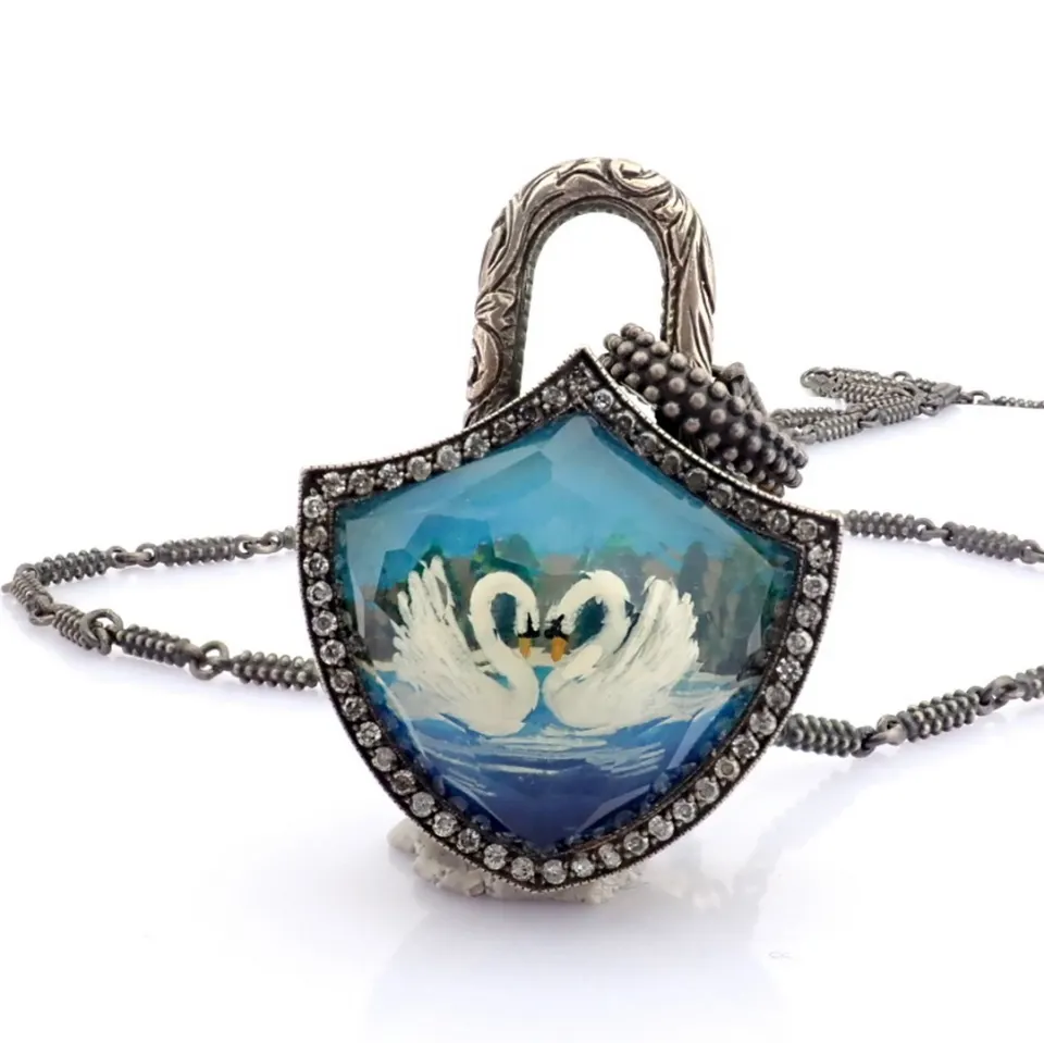 Clasp necklace embellished with gold, topaz, reversaly engraved intaglio swan and diamonds on silver