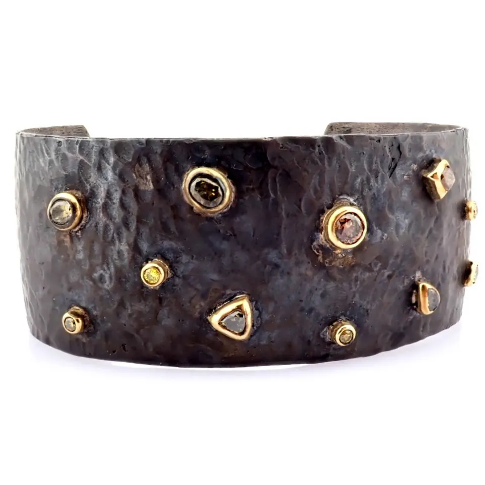 An exquisite bangle detailed with brilliant diamonds and gold on silver