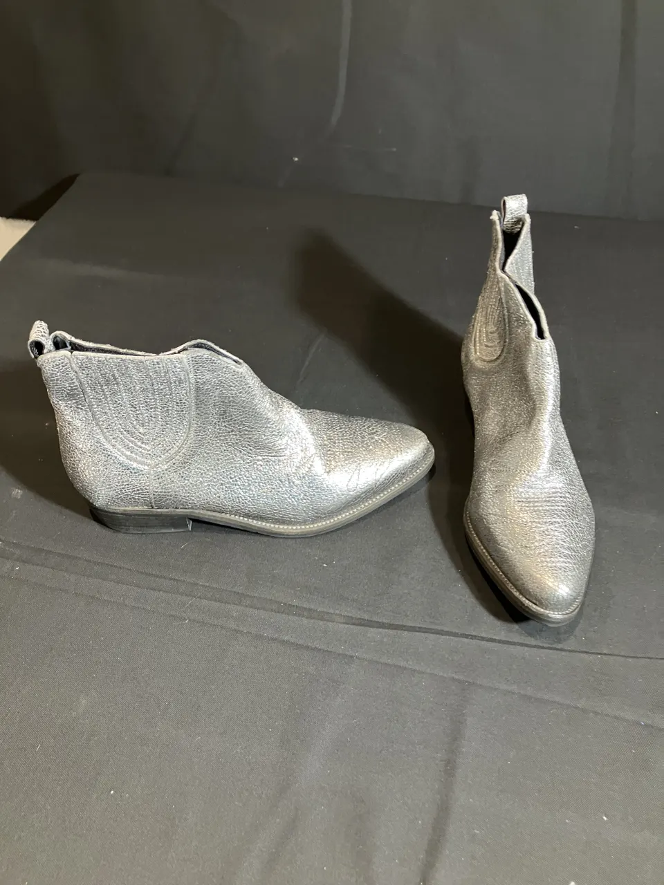 Hush silver boots worn by a body double