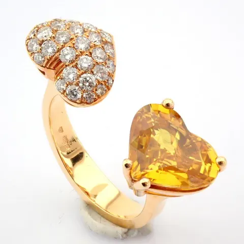 An exquisite heart ring  detailed with vibrand yellow heart cut sapphire and brilliant diamonds