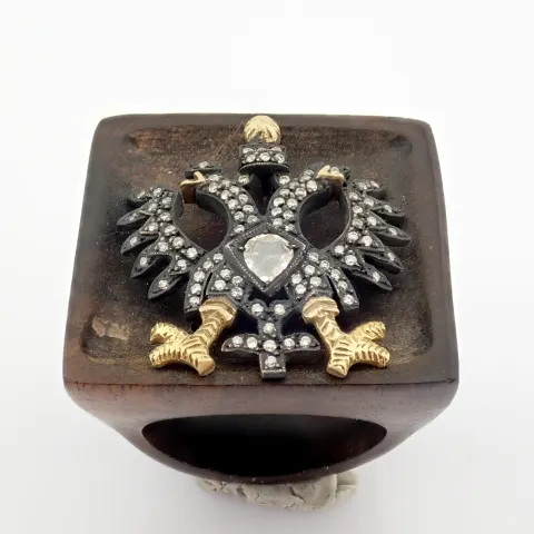 An Exquisite Eagle Ebony Ring Detailed With Brilliant Diamonds and Gold On Silver.