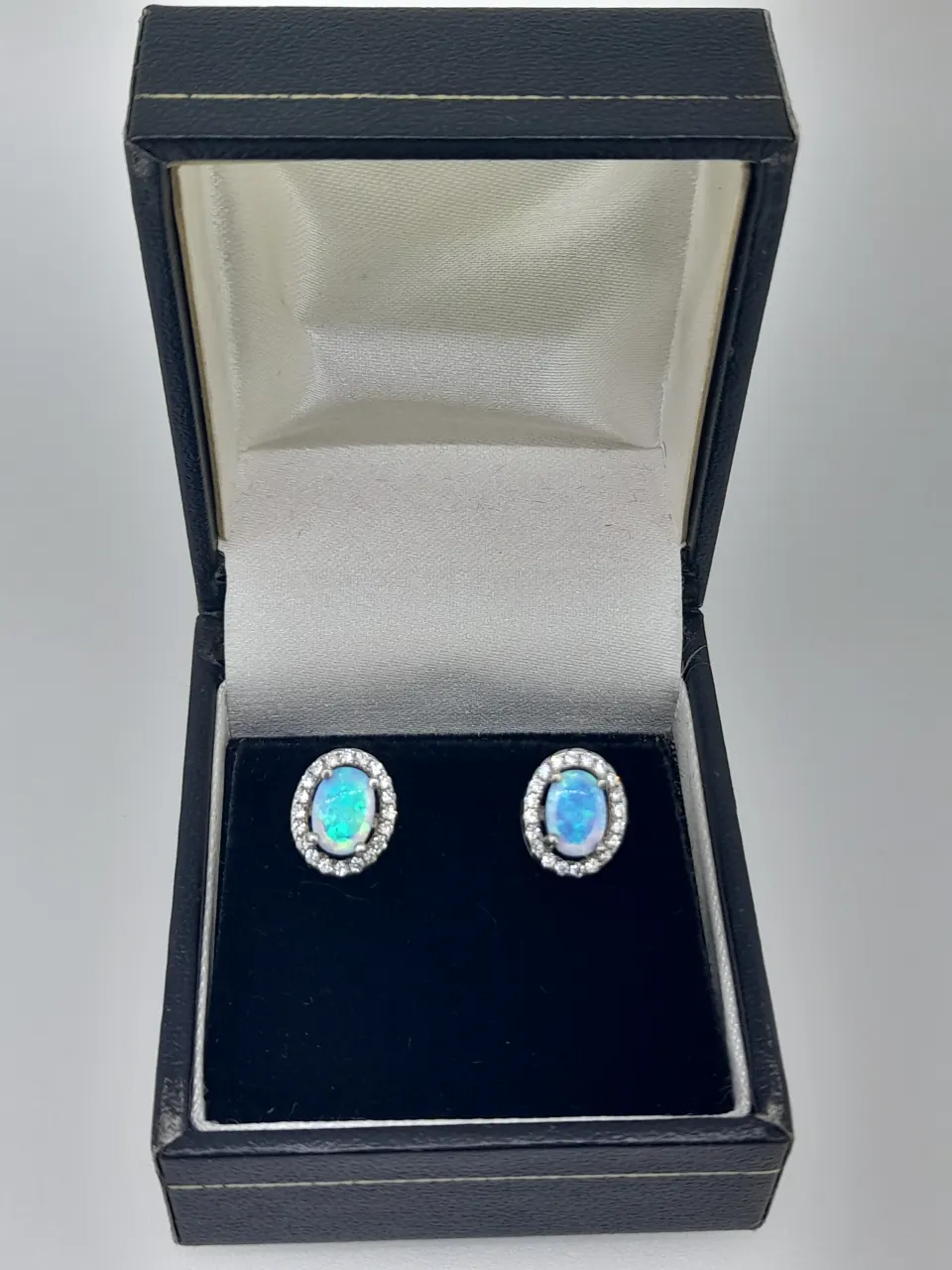 Silver and Synthetic Opal Stud Earring With CZ Halo
