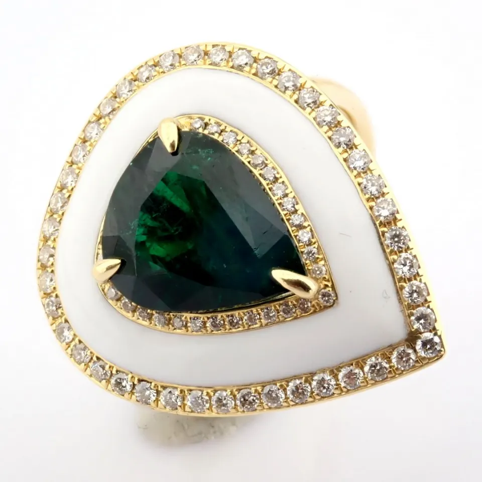 A Luxurious Gold Ring Featuring White Laser Enamel, Elegantly Adorned With Vibrant Emerald and Brill