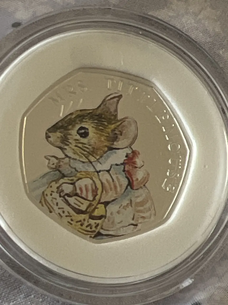 Silver coin depicting Mrs tittlemouse