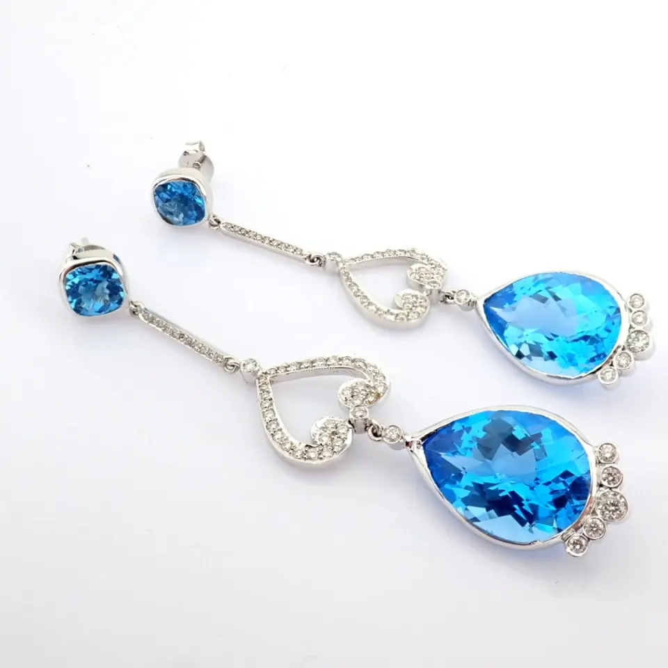 18K white gold earrings detailed with blue topaz and brilliant diamonds