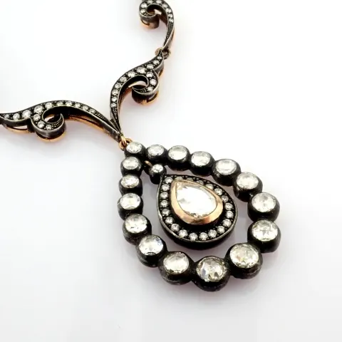 An Exquisite Necklace Detailed With Fancy Cut Diamonds and Gold In Silver