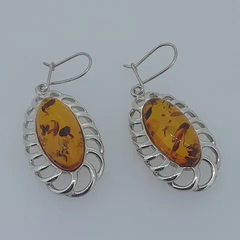 Silver earrings set with natural amber