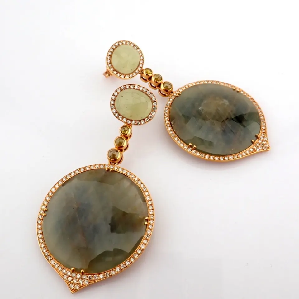 An Exquisite Gold Earrings Detailed With Slice Cut Rough Sapphire In The Centre and Brilliant Diamon