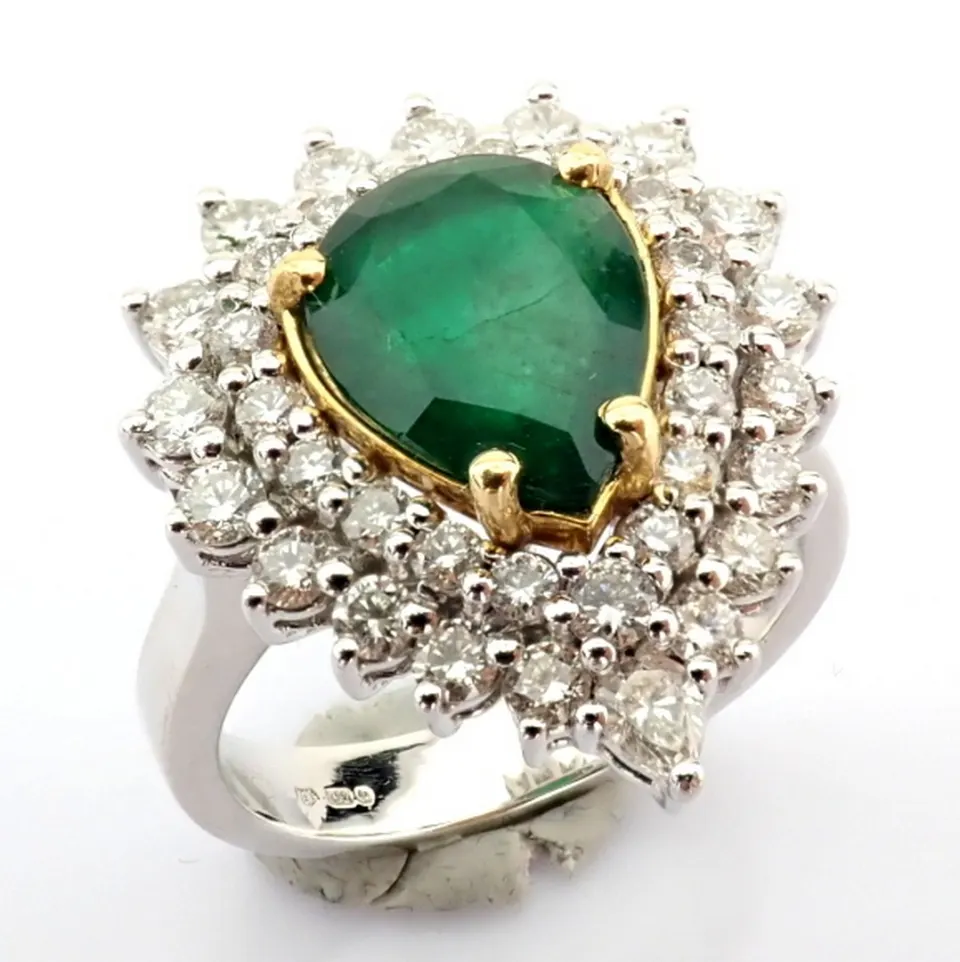 18K White gold cluster ring detailed with vibrand emerald and pear and brilliant diamonds