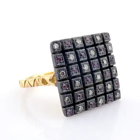 An Exquisite Ring Detailed With Pink Sapphires, Brilliant Diamonds and Gold On Silver.