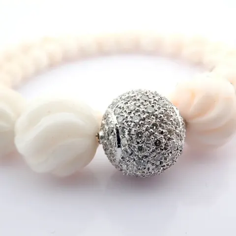 An exquisite coral necklace detailed with brilliant diamonds and gold