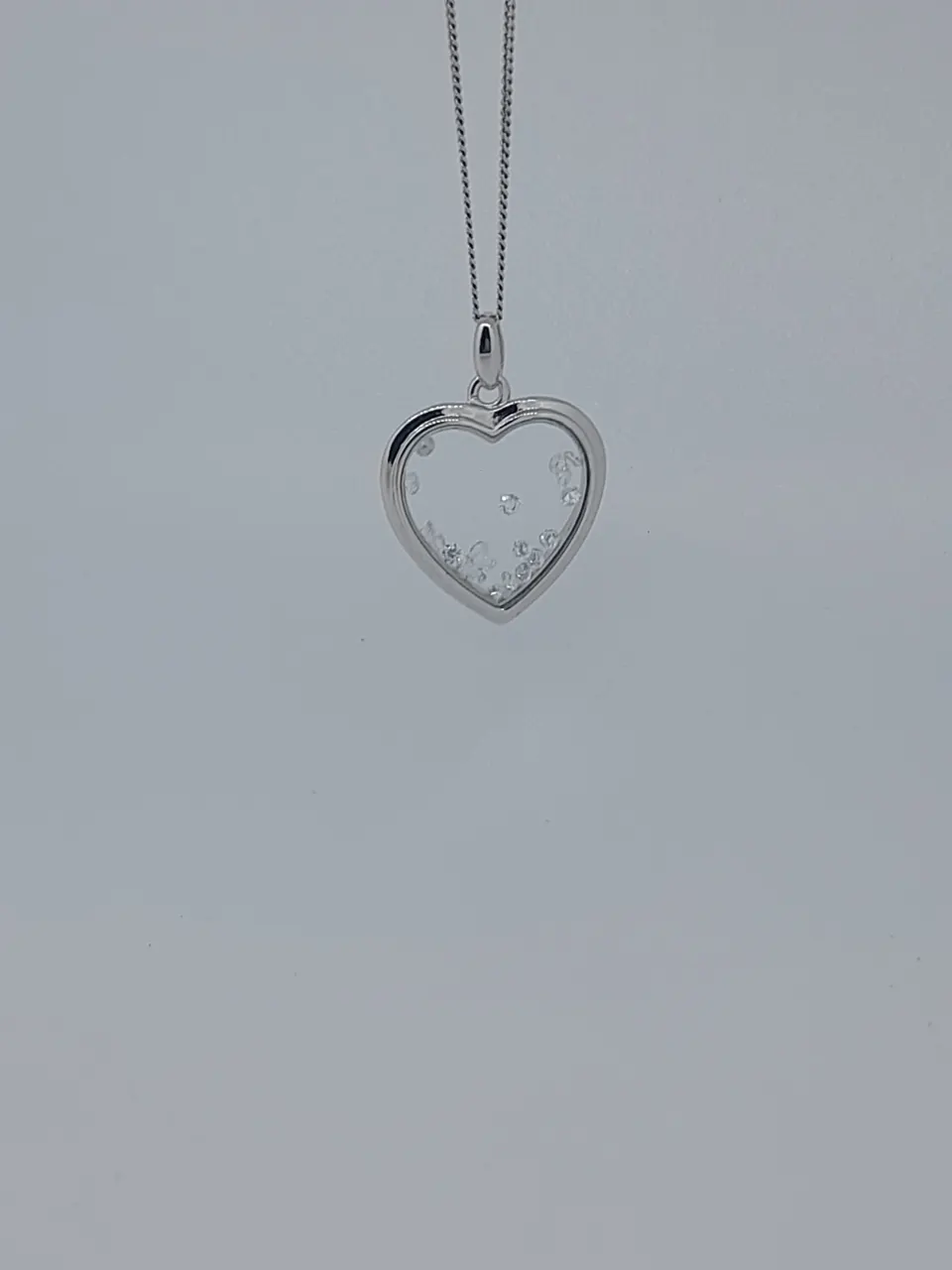 Silver Heart Shaped Pendant With Floating Stones