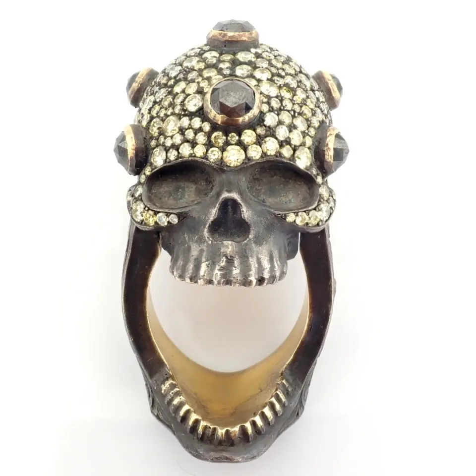 An exquisite hand-made skull  ring detailed with brilliant diamonds and gold on silver.