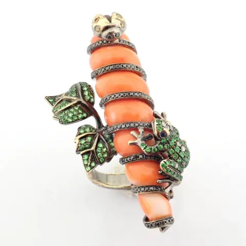 An exquisite ring detailed with coral, green garnet and brilliant diamonds
