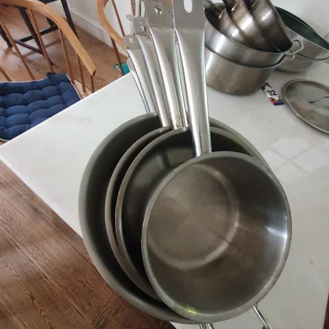 Set of 5  stainless steel, shallow pots.