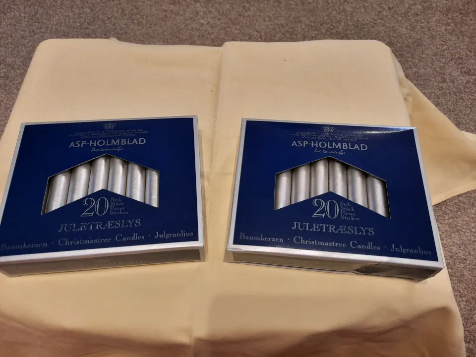 4 x packs small silver candles plus pack of longer candles