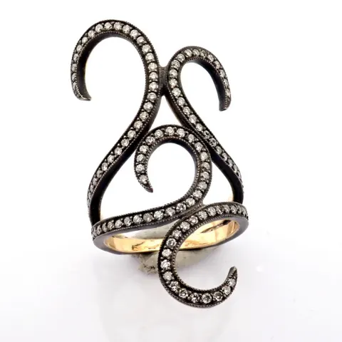 An exquisite ring detailed with brilliant diamonds and gold on silver.