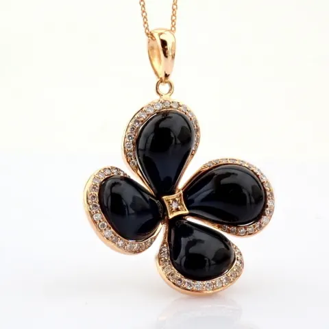An exquisite necklace detailed with onix, brilliant diamonds and gold.