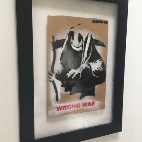 Banksy (b1974) ‘Wrong War’ & 6 Dismaland Bemusement Park Souvenirs Inc Framed Banksy Free Art, 2015