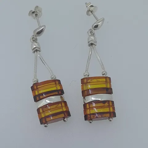 Silver drop earrings set with stacked graduated natural amber