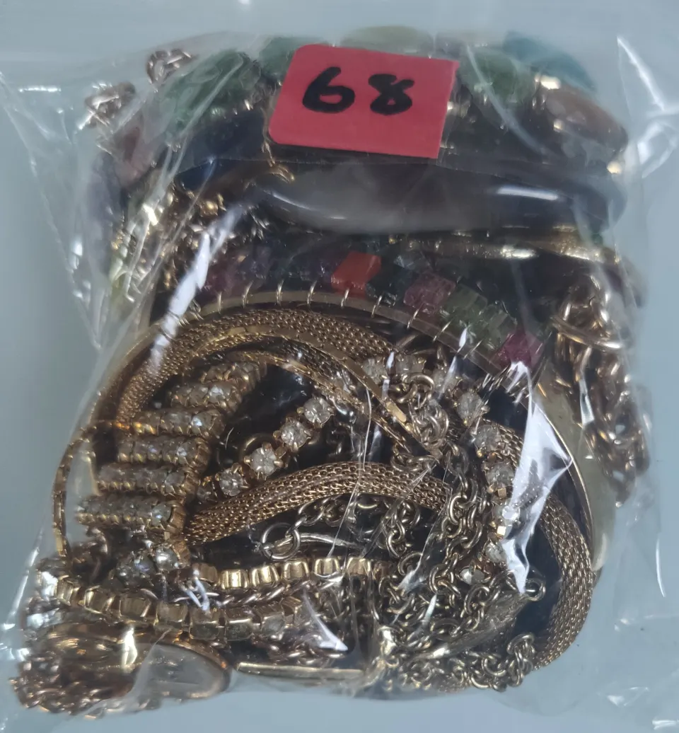 A collection of yellow metal jewellery in a bag. Approximately 379g.