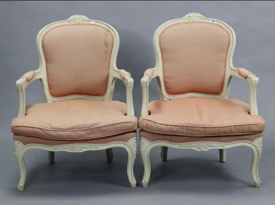 A pair of 18th century-style French cream painted & carved wooden-frame elbow chairs