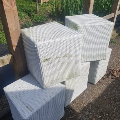 A set of 5 white rattan garden stools