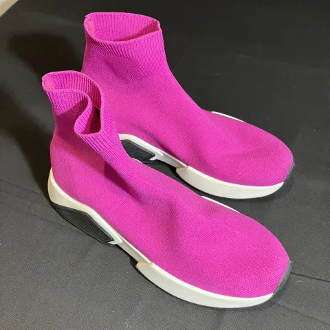 ASOS Pink Sock Trainers worn by a stunt double