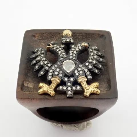 An exquisite  eagle ebony ring detailed with  brilliant diamonds and gold on silver.