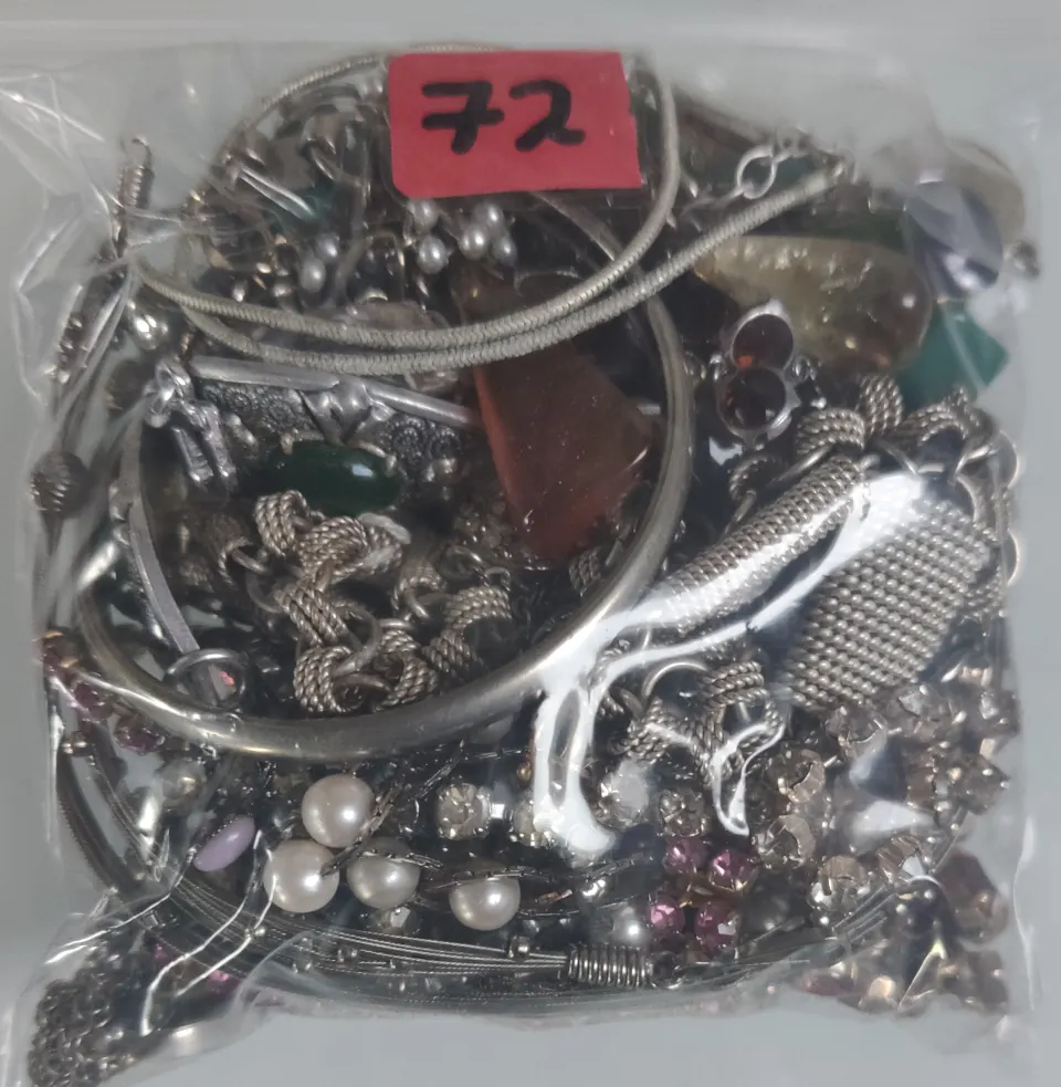 A collection of white metal jewellery in a bag. Approximately 296g.