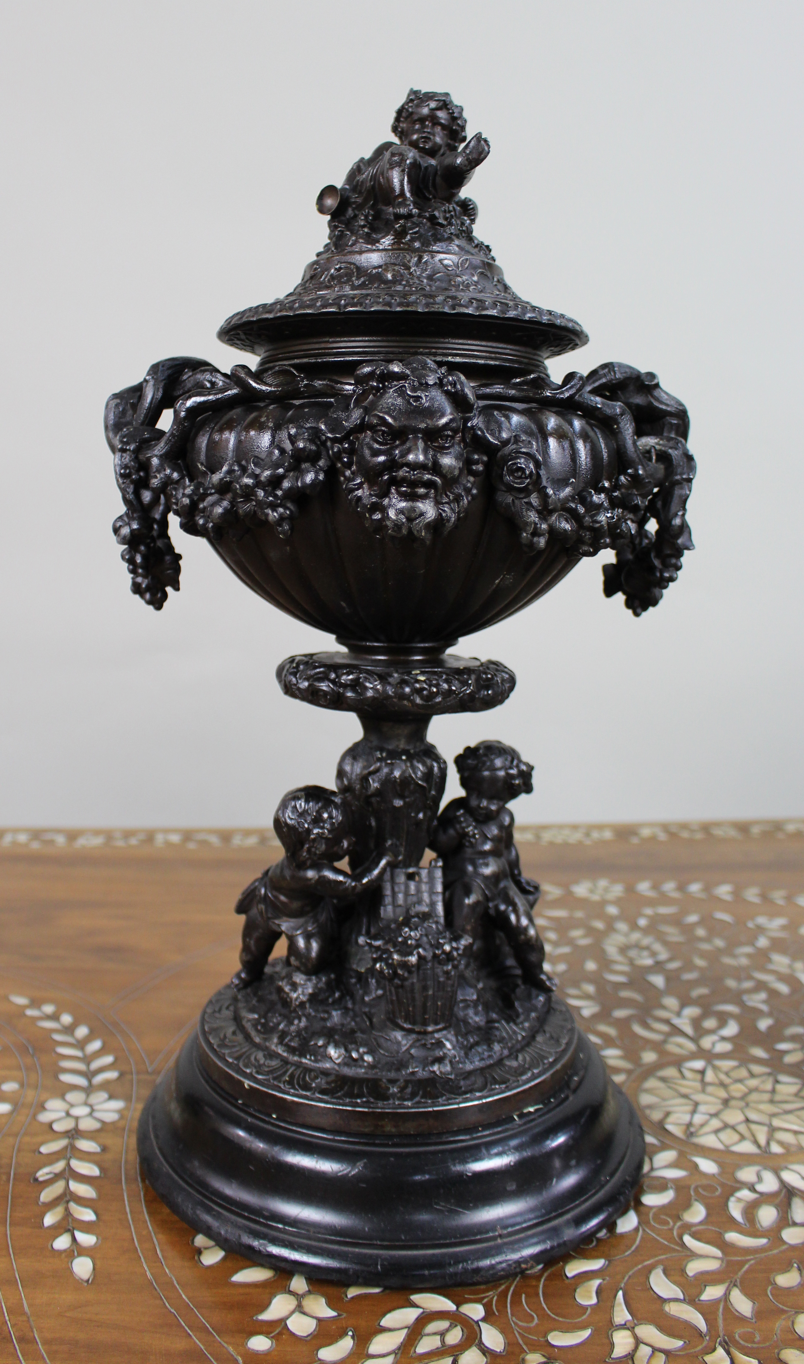 Pair of French Bronzed Spelter Urns with Bacchic Masks and Putti, Circa 1880