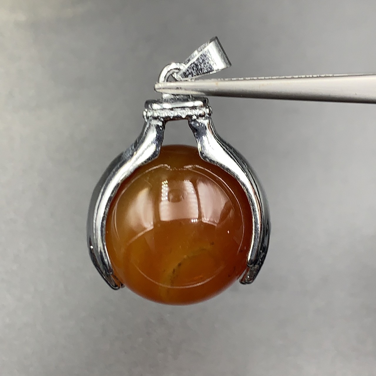 74.45Cts Awesome Natural Carnelian Sphere Agate With Holding Hands Stainless Steel Pendant. BCM-5