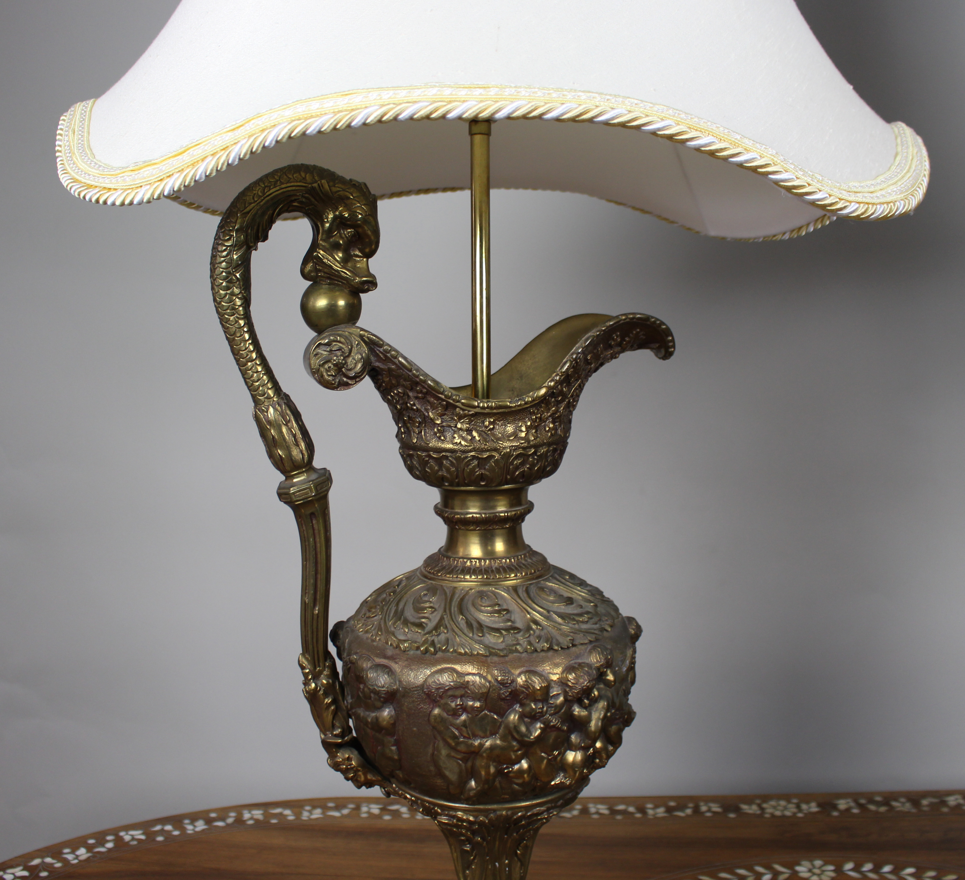 Pair of Early 20th Century French Neoclassical Ewer Lamps with Putti Relief