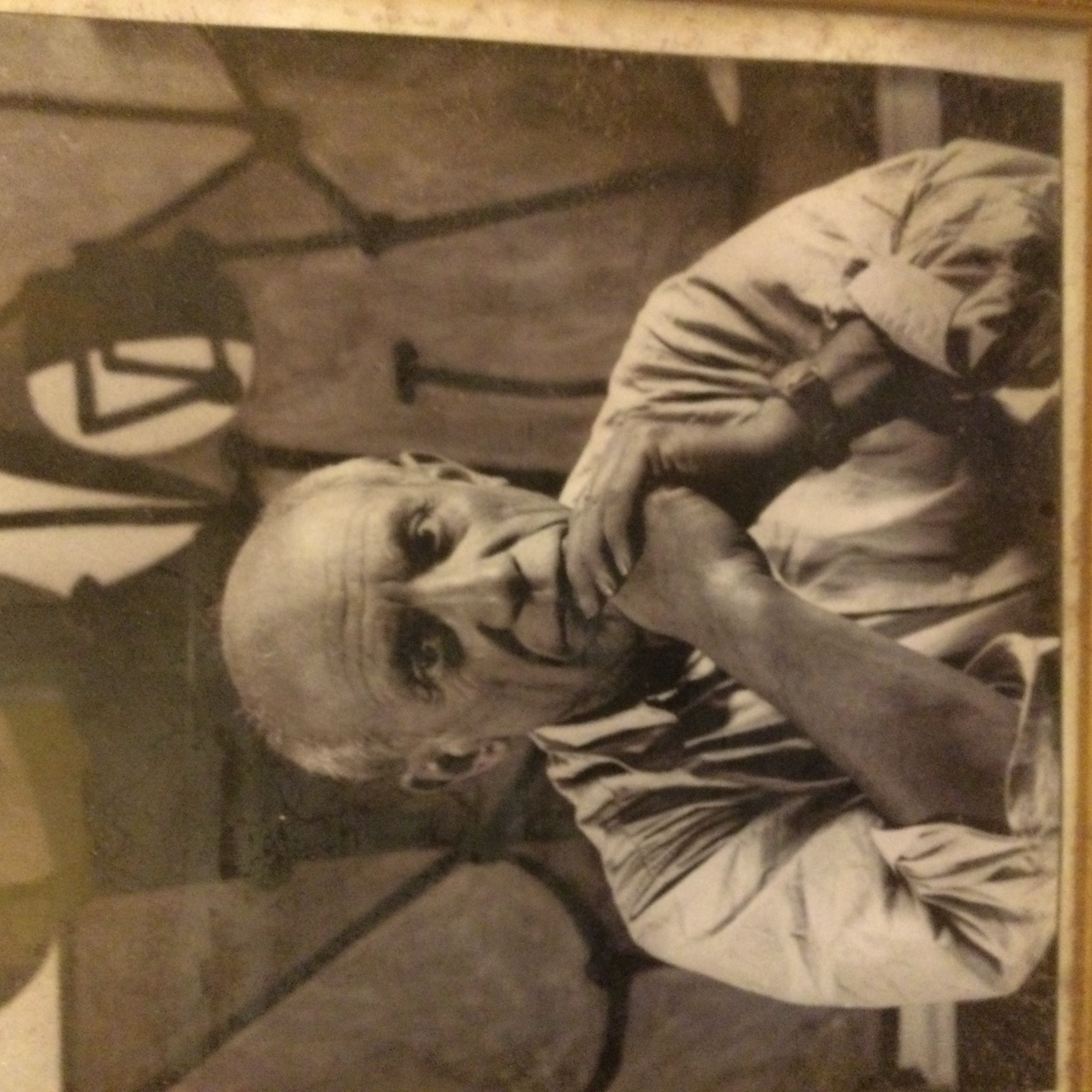 A Framed photograph of Pablo Picasso in his studio sat opposite his painting of La Cuisine in 1948